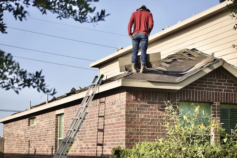 Professional roofer working on a residential roof in Affton